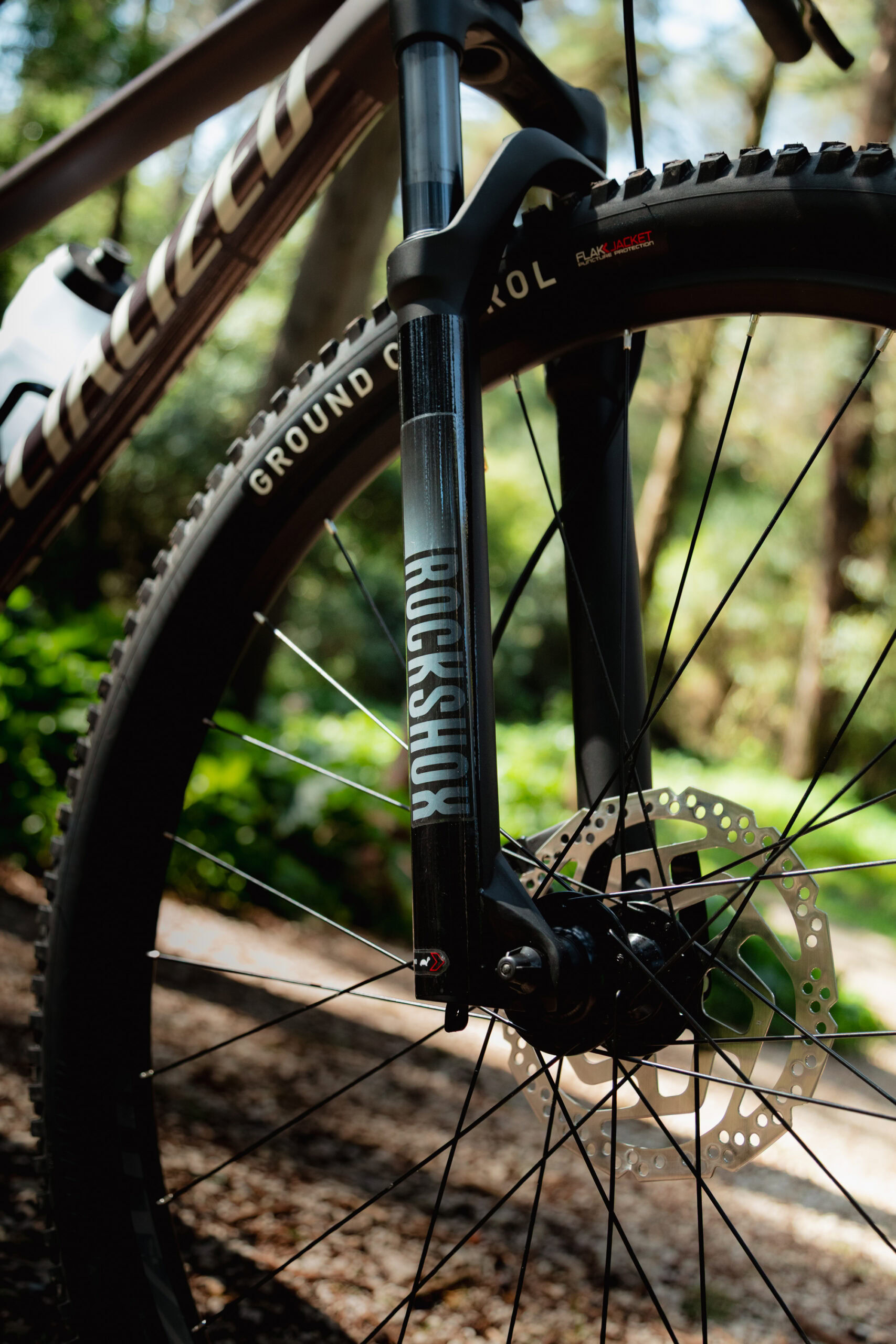 RockShox suspension fork and front wheel detail on Specialized Rockhopper Comp mountain bike