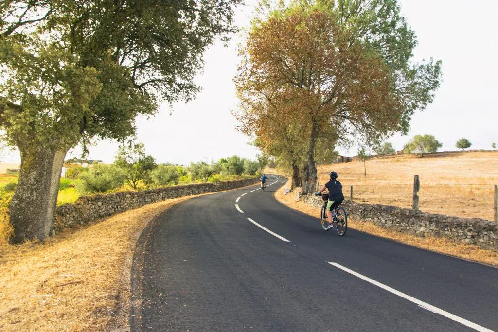 Cyclist riding through the peaceful countryside roads of Alentejo, Portugal